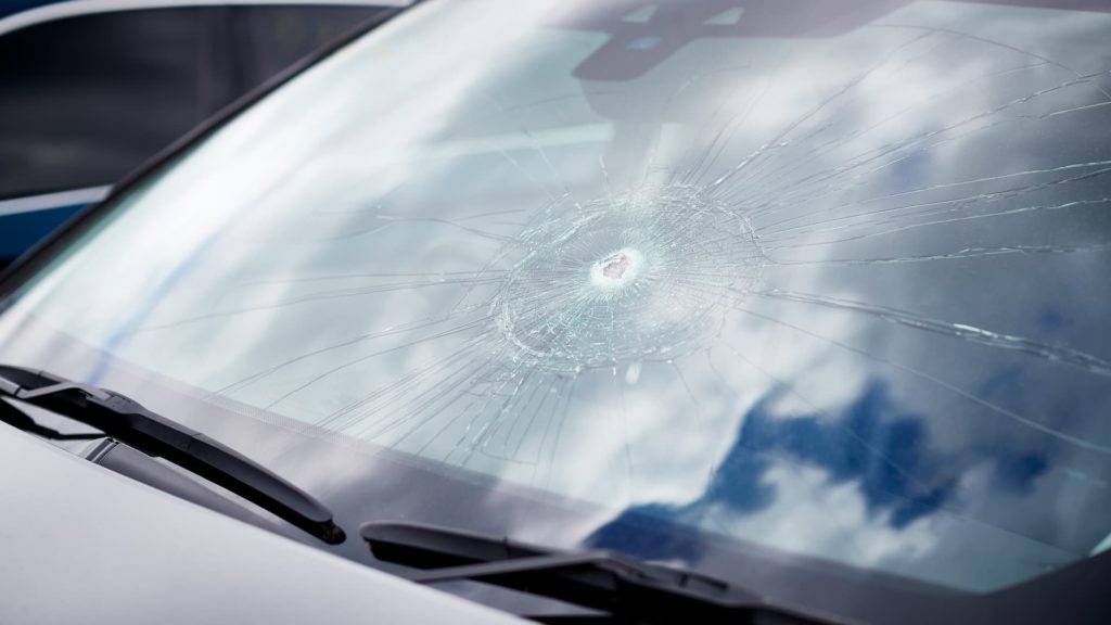 Front Windscreen Of A Car With A Large Impact Chip And Cracks Surrounding It